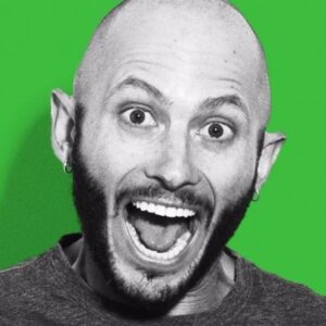 A bald man with his mouth open, surrounded by a vibrant green background.